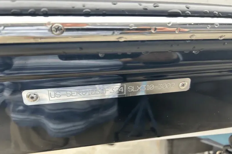 Slide: The Image of 2024 Sea Ray SLX 310 boat identification plate with water droplets. - 27