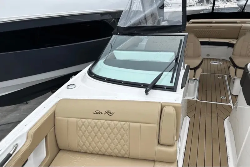 Slide: The Image of 2024 Sea Ray SLX 310 boat interior with tan leather seating and wood flooring. - 47
