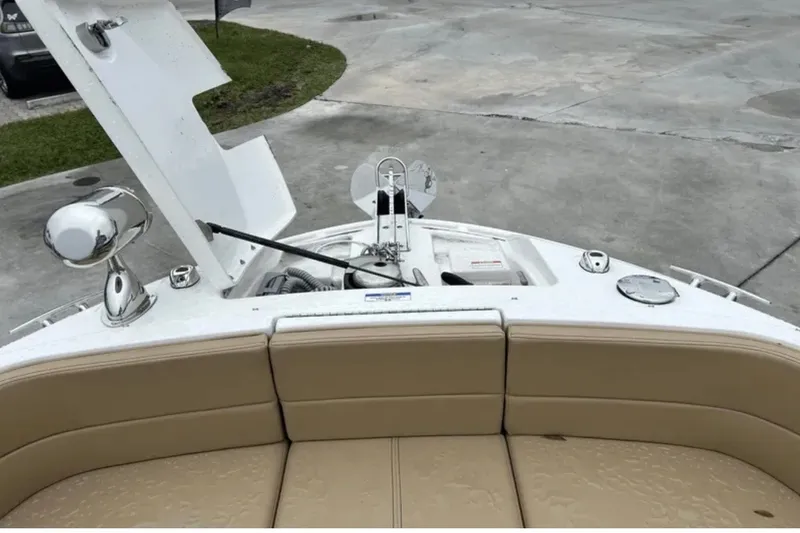 Slide: The Image of 2024 Sea Ray SLX 310 boat bow with open hatch and beige seating. - 48