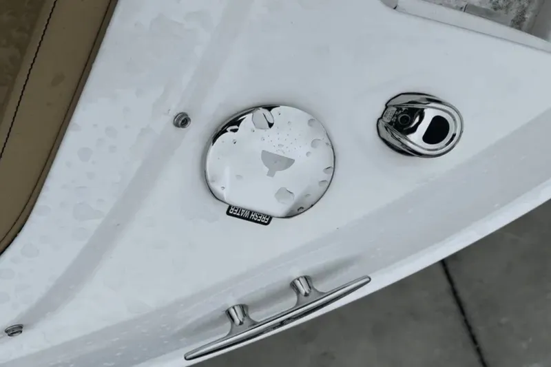 Slide: The Image of 2024 Sea Ray SLX 310 boat detail with fresh water cap and cleat. - 49