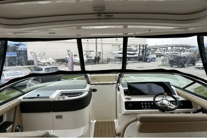 Slide: The Image of 2024 Sea Ray SLX 310 boat interior with modern dashboard and steering wheel. - 30