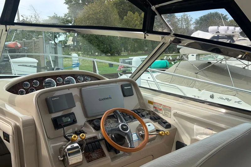 Slide: The Image of 1999 Sea Ray 370 Express Cruiser helm with Garmin navigation system and control panel. - 19