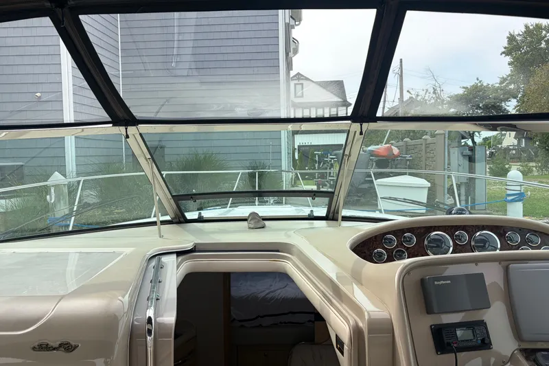 Slide: The Image of 1999 Sea Ray 370 Express Cruiser cockpit with dashboard and open cabin door. - 18