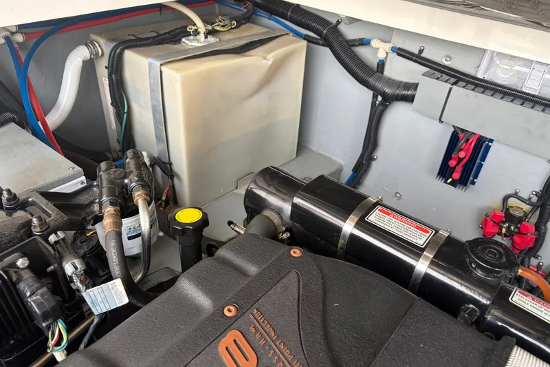 Slide: The Image of Engine compartment of a 1999 Sea Ray 370 Express Cruiser, showcasing mechanical components. - 35