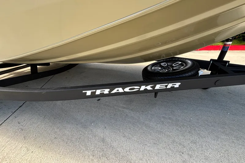 Slide: The Image of 2026 Tracker Pro Team 195 boat trailer with spare tire on concrete surface. - 40