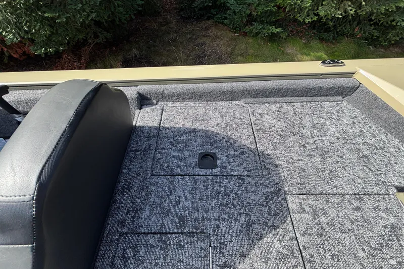 Slide: The Image of Interior view of 2026 Tracker Pro Team 195 boat with gray carpeted flooring. - 20