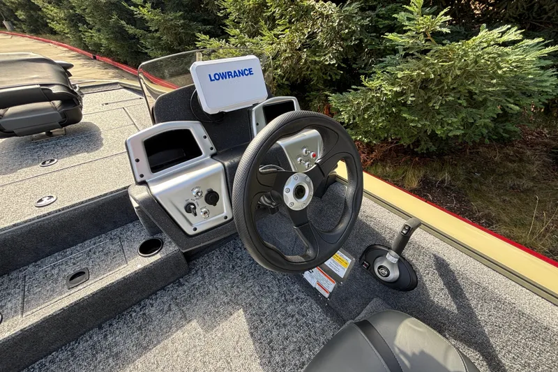 Slide: The Image of 2026 Tracker Pro Team 195 boat dashboard with steering wheel and controls. - 21