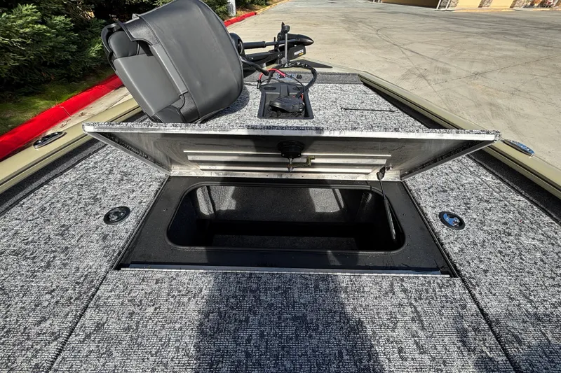 Slide: The Image of 2026 Tracker Pro Team 195 boat with open storage compartment and seat. - 26
