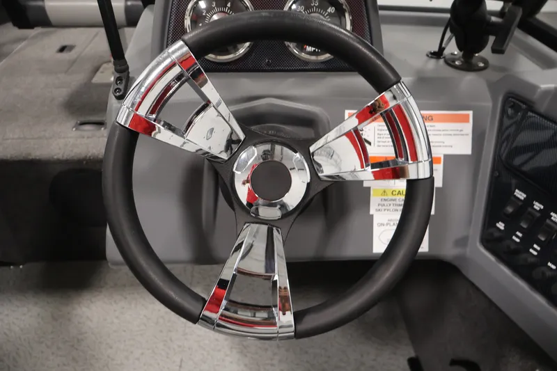 Slide: The Image of Steering wheel of 2022 Lowe Fishing Machine 1625WT boat, featuring chrome accents. - 21