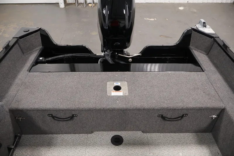 Slide: The Image of 2022 Lowe Fishing Machine 1625WT boat interior with motor and storage compartments. - 34