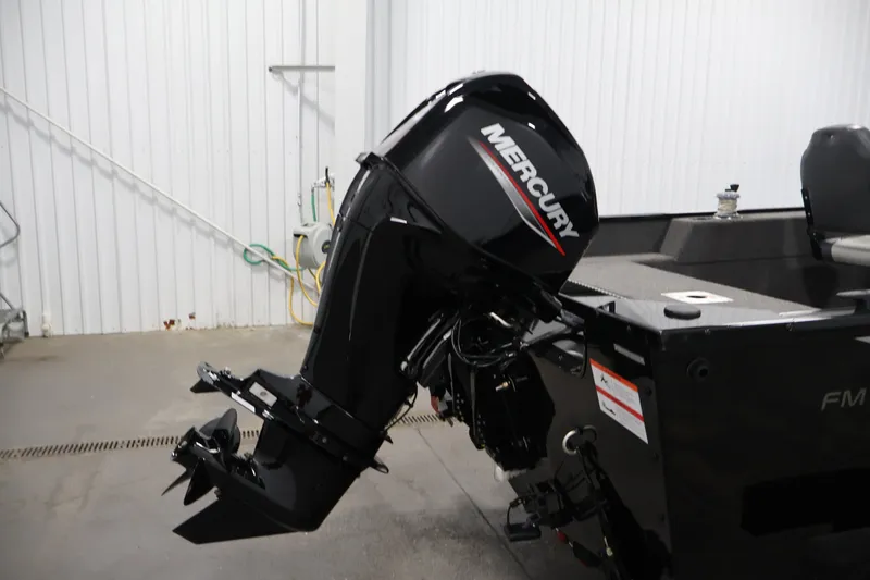 Slide: The Image of 2022 Lowe Fishing Machine 1625WT with Mercury outboard motor in a garage setting. - 36