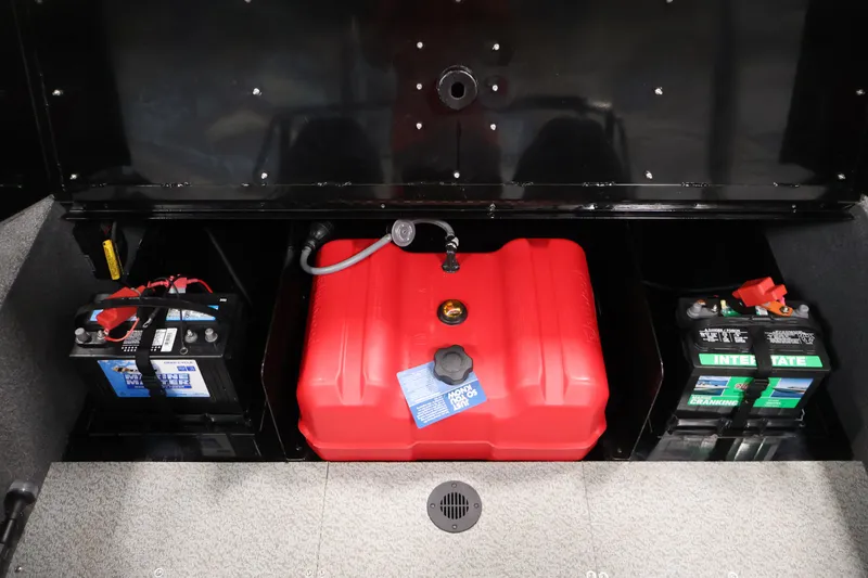 Slide: The Image of 2022 Lowe Fishing Machine 1625WT battery and fuel compartment with red fuel tank. - 35