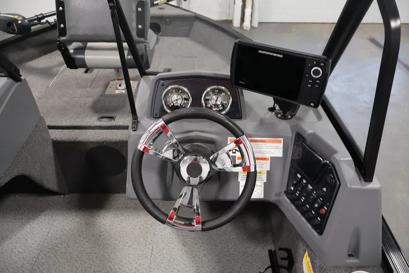 Slide: The Image of 2022 Lowe Fishing Machine 1625WT dashboard with steering wheel and Humminbird fish finder. - 20
