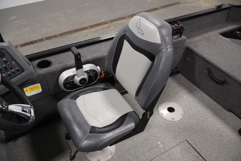 Slide: The Image of 2022 Lowe Fishing Machine 1625WT interior with steering console and cushioned seat. - 26