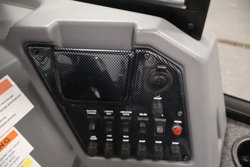 Slide: The Image of Control panel of 2022 Lowe Fishing Machine 1625WT with switches and 12V outlet. - 24