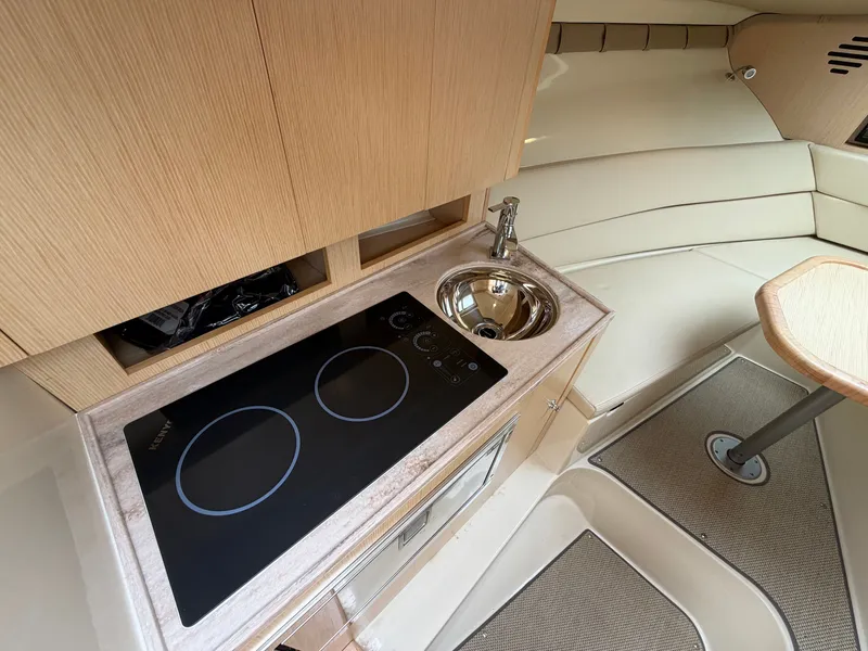 Slide: The Image of Interior of the Chris-Craft Corsair 34 with kitchenette, sink, and seating area. - 39