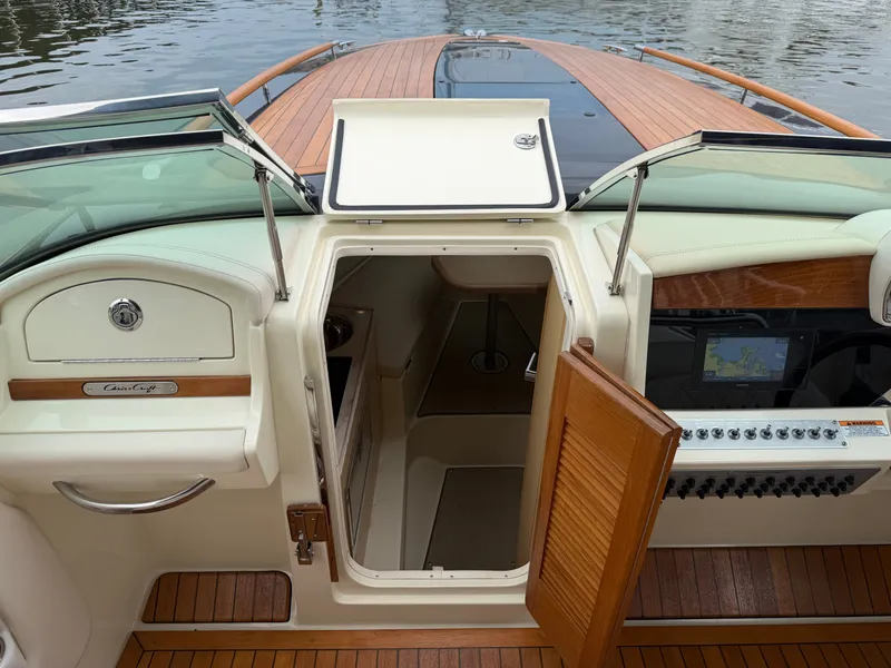 Slide: The Image of The image shows the cockpit of a 2020 Chris-Craft Corsair 34 with wood flooring and modern electronics. - 37