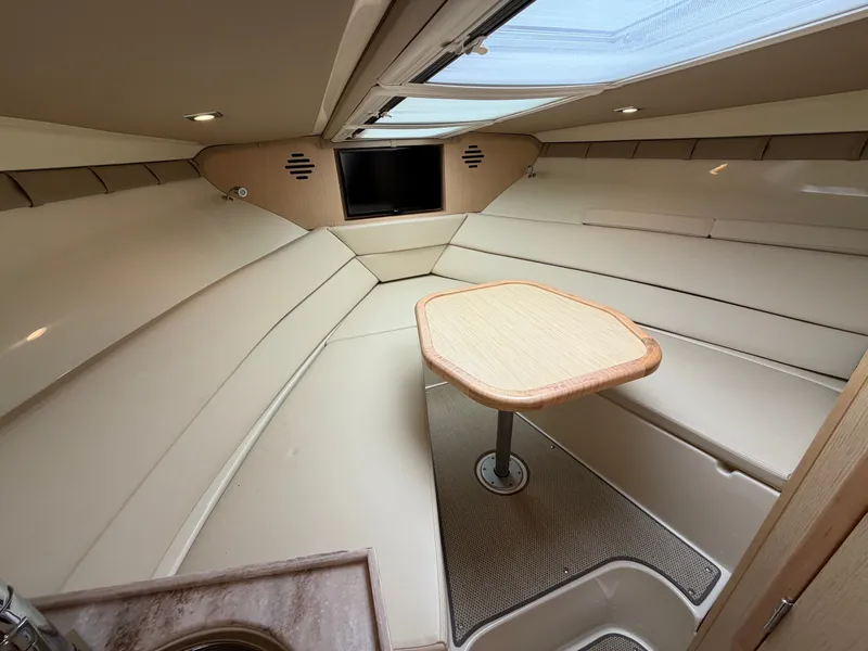 Slide: The Image of Interior of a 2020 Chris-Craft Corsair 34 with cream-colored seating and a wooden table. - 40