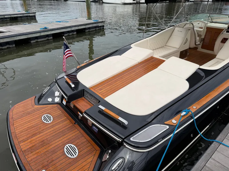 Slide: The Image of 2020 Chris-Craft Corsair 34 at dock with elegant wood accents and comfortable seating. - 21