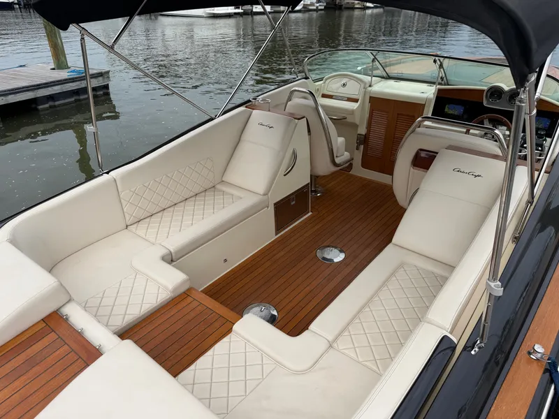 Slide: The Image of The image shows the cockpit of a 2020 Chris-Craft Corsair 34 with elegant cream upholstery and wooden flooring. - 22