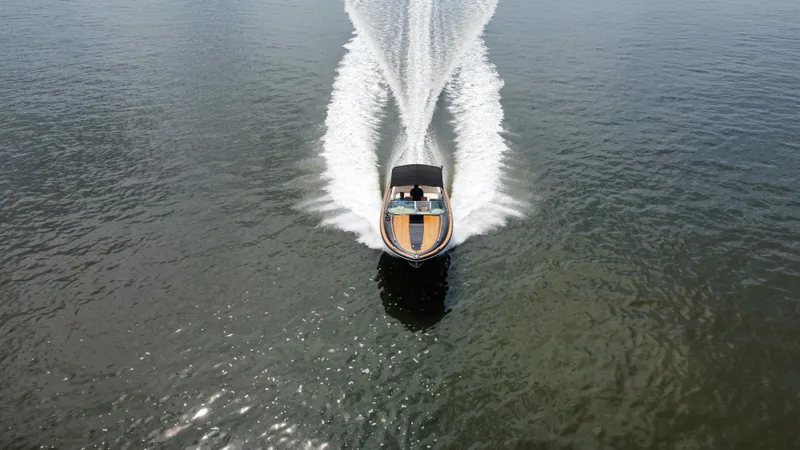 Slide: The Image of 2020 Chris-Craft Corsair 34 speeding across the water, leaving a wide wake behind. - 12
