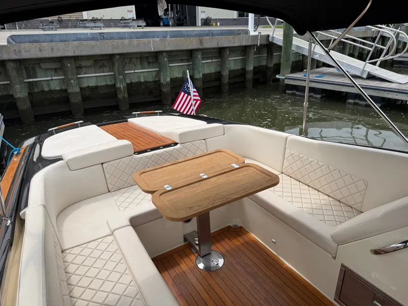 Slide: The Image of 2020 Chris-Craft Corsair 34 with elegant seating area and wooden table at the dock. - 33