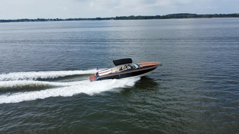 Slide: The Image of A 2020 Chris-Craft Corsair 34 speeds across the water, with one person on board. - 4