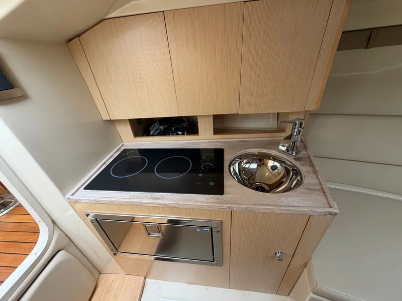 Slide: The Image of The 2020 Chris-Craft Corsair 34 galley features a cooktop and a round sink. - 46