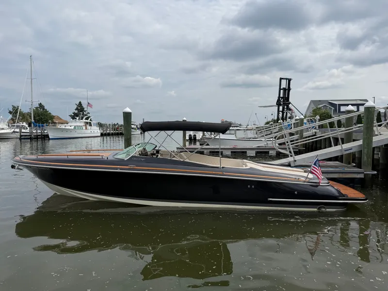 Slide: The Image of 2020 Chris-Craft Corsair 34 docked, featuring sleek design and an American flag. - 17