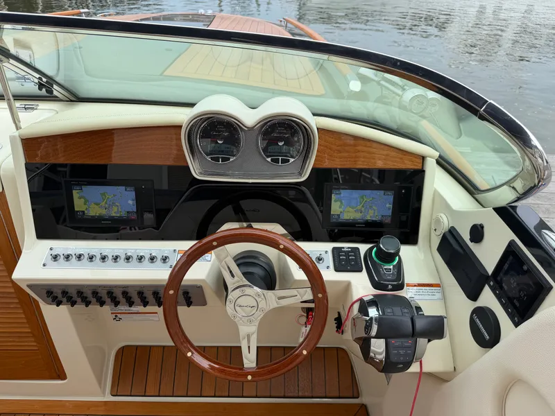 Slide: The Image of The cockpit of the 2020 Chris-Craft Corsair 34 features elegant wood accents and modern instruments. - 29