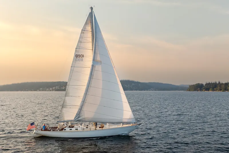 The Image of Vintage 1970 Sparkman & Stephens 57 sailboat cruising on serene waters at sunset. - 0