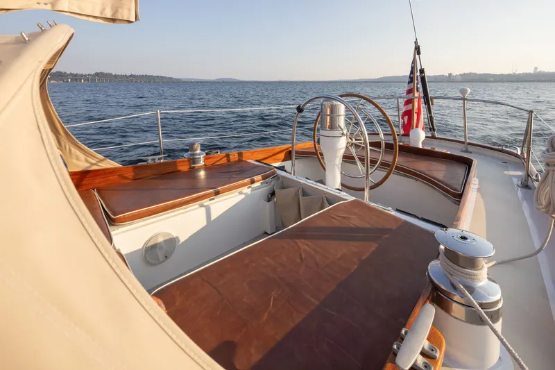 Slide: The Image of Cockpit of 1970 Sparkman & Stephens 57 yacht with wooden accents and ocean view. - 24