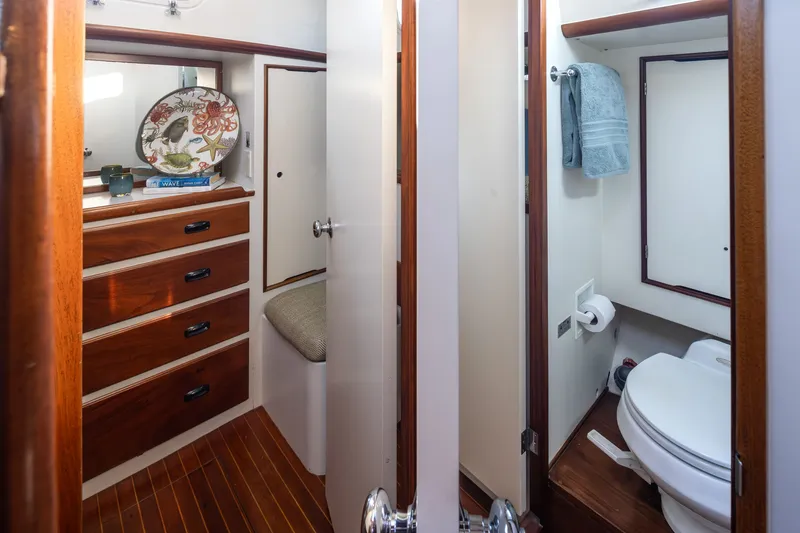 Slide: The Image of Interior of 1970 Sparkman & Stephens 57 yacht with wooden drawers and compact bathroom. - 9
