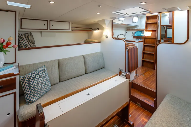 Slide: The Image of Interior of a 1970 Sparkman & Stephens 57 yacht, featuring elegant wood finishes and cozy seating. - 4