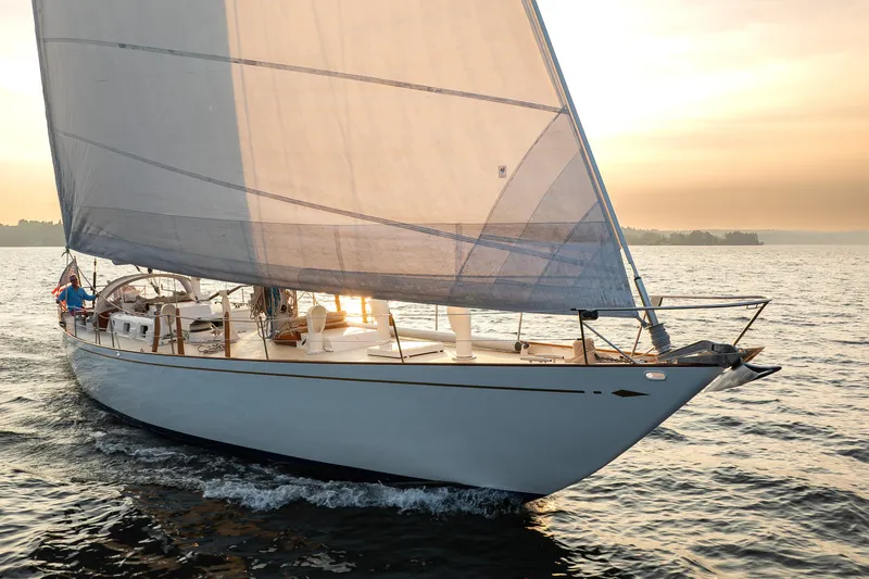 Slide: The Image of Sailing yacht Sparkman & Stephens 57, 1970 model, gliding on serene waters at sunset. - 28