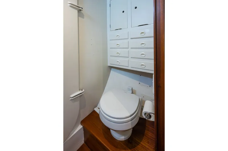 Slide: The Image of Compact bathroom with white cabinetry and toilet on a 1970 Sparkman & Stephens 57 yacht. - 20