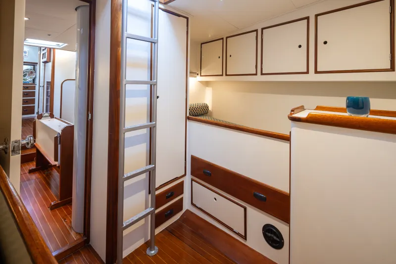 Slide: The Image of Interior of 1970 Sparkman & Stephens 57 yacht with wooden accents and storage cabinets. - 15