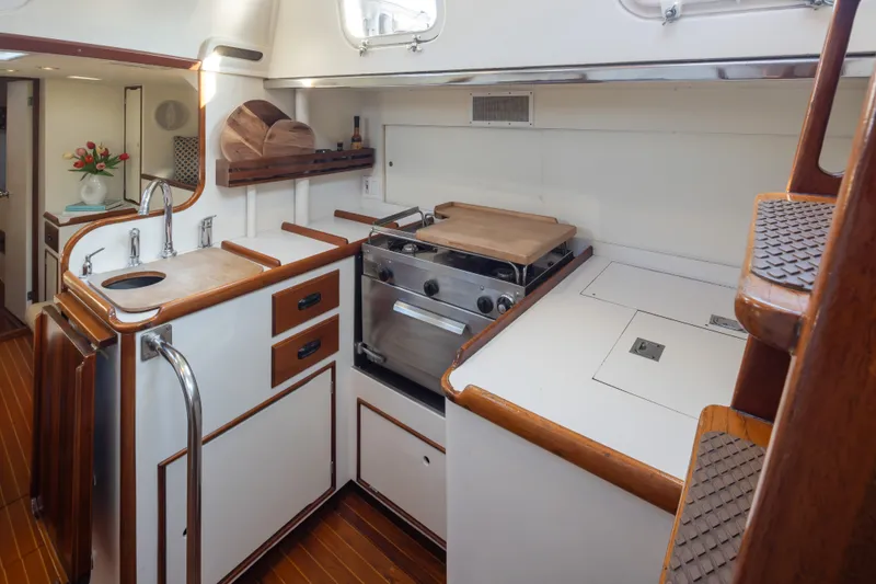 Slide: The Image of Vintage 1970 Sparkman & Stephens 57 yacht kitchen with wood accents and modern appliances. - 8