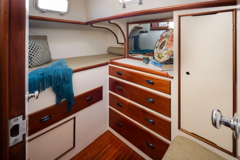 Slide: The Image of Cozy cabin interior of 1970 Sparkman & Stephens 57 yacht with wooden drawers and bedding. - 10