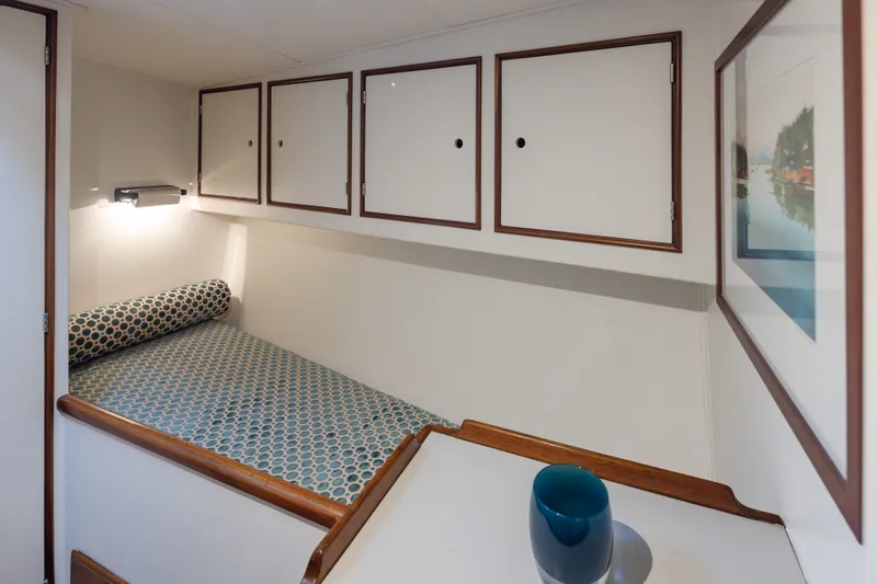 Slide: The Image of Cozy cabin interior of 1970 Sparkman & Stephens 57 yacht with patterned bedding and storage. - 16