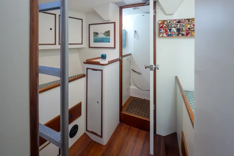 Slide: The Image of Interior of 1970 Sparkman & Stephens 57 yacht, featuring wooden flooring and nautical decor. - 13