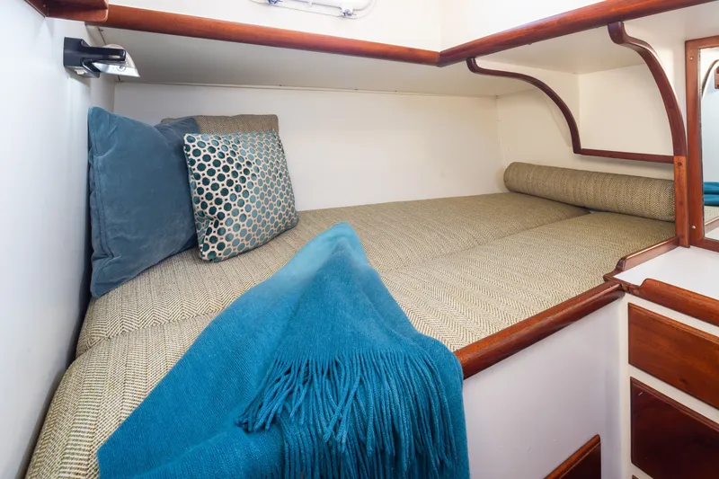 Slide: The Image of Cozy cabin interior of 1970 Sparkman & Stephens 57 yacht with cushions and blue throw. - 11