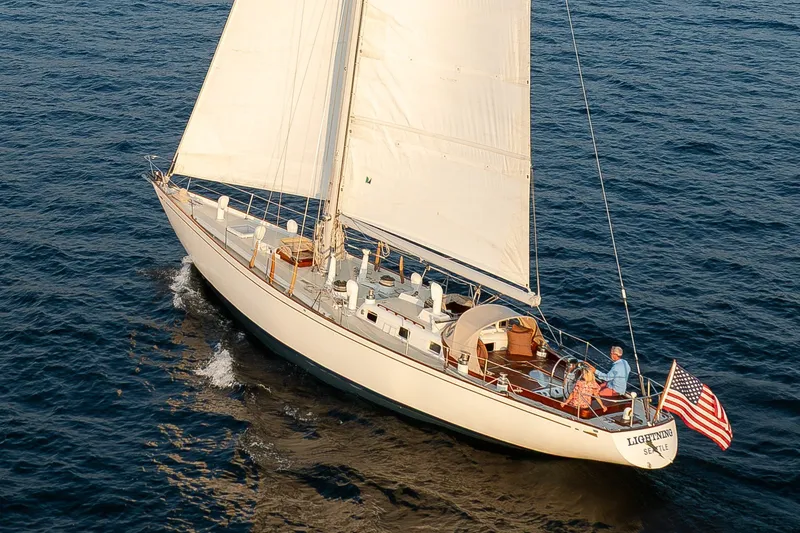 The Image of Sailing yacht Sparkman & Stephens 57, 1970, cruising on open water with American flag. - 0
