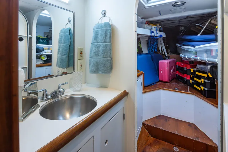 Slide: The Image of Bathroom and storage area on a 1970 Sparkman & Stephens 57 yacht, featuring sink and organized shelves. - 17