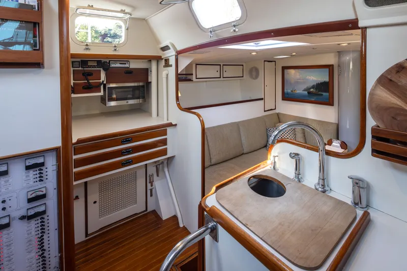 Slide: The Image of Interior of a 1970 Sparkman & Stephens 57 yacht with modern kitchen and cozy seating area. - 5