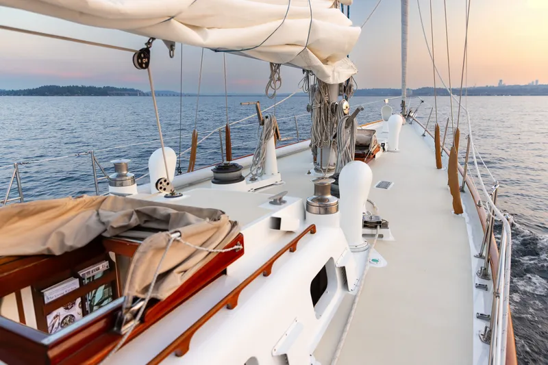 Slide: The Image of Sailing yacht deck of 1970 Sparkman & Stephens 57, cruising at sunset on calm waters. - 22