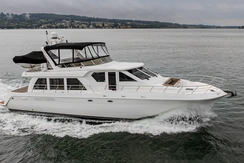 Slide: The Image of 2004 Navigator Pilothouse yacht cruising on a calm lake under cloudy skies. - 48