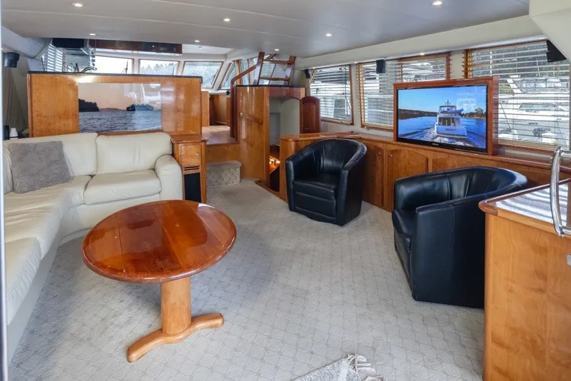 Slide: The Image of Luxurious 2004 Navigator Pilothouse yacht interior with leather seating, wooden accents, and large windows. - 9