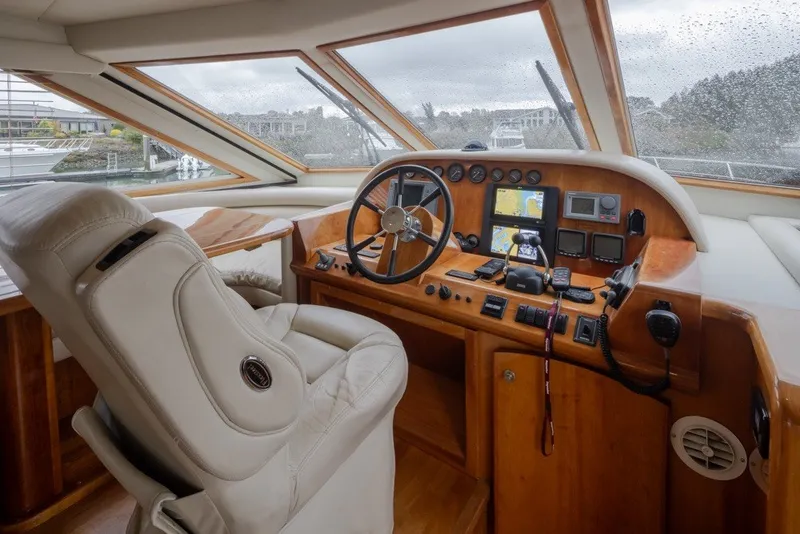 Slide: The Image of Luxurious 2004 Navigator Pilothouse yacht interior with steering wheel and navigation equipment. - 18