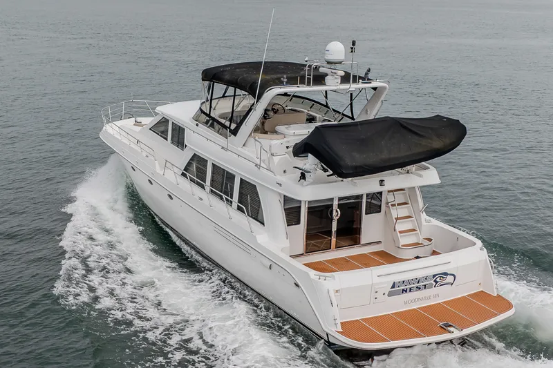Slide: The Image of 2004 Navigator Pilothouse yacht cruising on open water, rear view. - 45